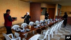 FILE—Residents displaced from their homes in southern Lebanon prepare a communal Iftar meal for Ramadan, in Marwanieh, Lebanon, March 15, 2024.