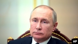 Russian President Vladimir Putin attends a video conference meeting in Moscow, Russia, April 23, 2021. 
