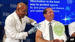 B.K. Morris gives Secretary of Health and Human Services Alex Azar a flu shot to during a news conference in Washington, Sept. 26, 2019. Health officials urged Americans not to delay getting their flu shot.