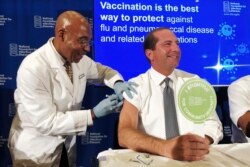 Secretary of Health and Human Services Alex Azar gets a flu shot to during a news conference in Washington, Sept. 26, 2019.