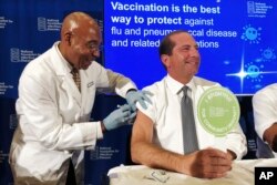 Secretary of Health and Human Services Alex Azar gets a flu shot to during a news conference in Washington, Sept. 26, 2019.