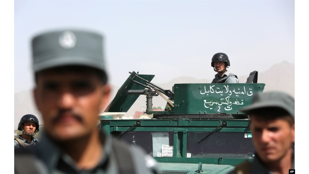 FILE - Afghan security forces inspect site of suicide attack after clashes with Taliban fighters at the gate of an intelligence facility in Kabul, July 7, 2015.
