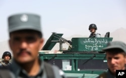 FILE - Afghan security forces inspect site of suicide attack after clashes with Taliban fighters at the gate of an intelligence facility in Kabul, July 7, 2015.