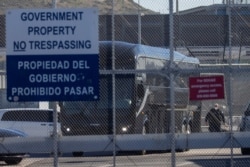 A bus leaves a closed border facility as migrants subject to a Trump-era asylum restriction program were expected to begin entry into the United States at the San Ysidro border crossing with Mexico, in San Diego, California, Feb. 19, 2021.