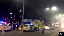 FILE - In this image taken from video made available by Gem News, police attend the scene of an explosion in Leicester, central England, Feb. 25, 2018. Five people died in the blast; three men now have been charged in the case