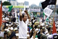 FILE - A Muslim man shouts slogans during a rally against Jakarta's minority Christian Governor Basuki "Ahok" Tjahaja Purnama demanding him to be sacked outside the parliament in Jakarta, Indonesia, Feb. 21, 2017.