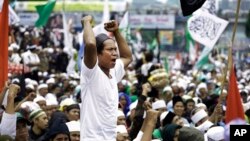 FILE - A Muslim man shouts slogans during a rally against Jakarta's minority Christian Governor Basuki "Ahok" Tjahaja Purnama demanding him to be sacked outside the parliament in Jakarta, Indonesia, Feb. 21, 2017.