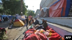 Iraqi anti-government protesters are pictured where they sleep on the side of a road in Baghdad's Tahrir Square, Nov. 20, 2019.