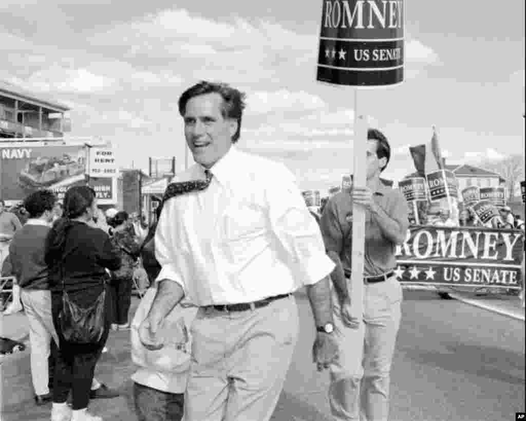 Republican U.S. senatorial candidate Mitt Romney greets supporters at the Columbus Day parade in Worcester, Mass., following his father's path into politics, October 10, 1994.