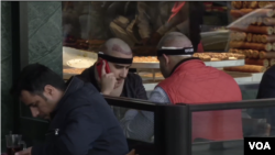 Men with bands around their heads from recent hair transplant surgery at a cafe in Istanbul’s Taksim Square.