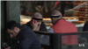 Men with bands around their heads from recent hair transplant surgery at a cafe in Istanbul’s Taksim Square.