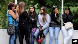 Women related to men who fought alongside the rebel police officer Oscar Perez wait for their loved ones' bodies to be turned over, outside the morgue in Caracas, Venezuela, Jan. 17, 2018. Seven people died fighting against police and soldiers Monday in a small mountain community outside of Caracas, according to Interior Minister Nestor Reverol.