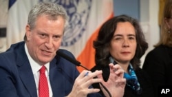 FILE - Mayor Bill de Blasio, left, is shown with Dr. Oxiris Barbot, commissioner of the New York City Department of Health and Mental Hygiene, in New York, Feb. 26, 2020.