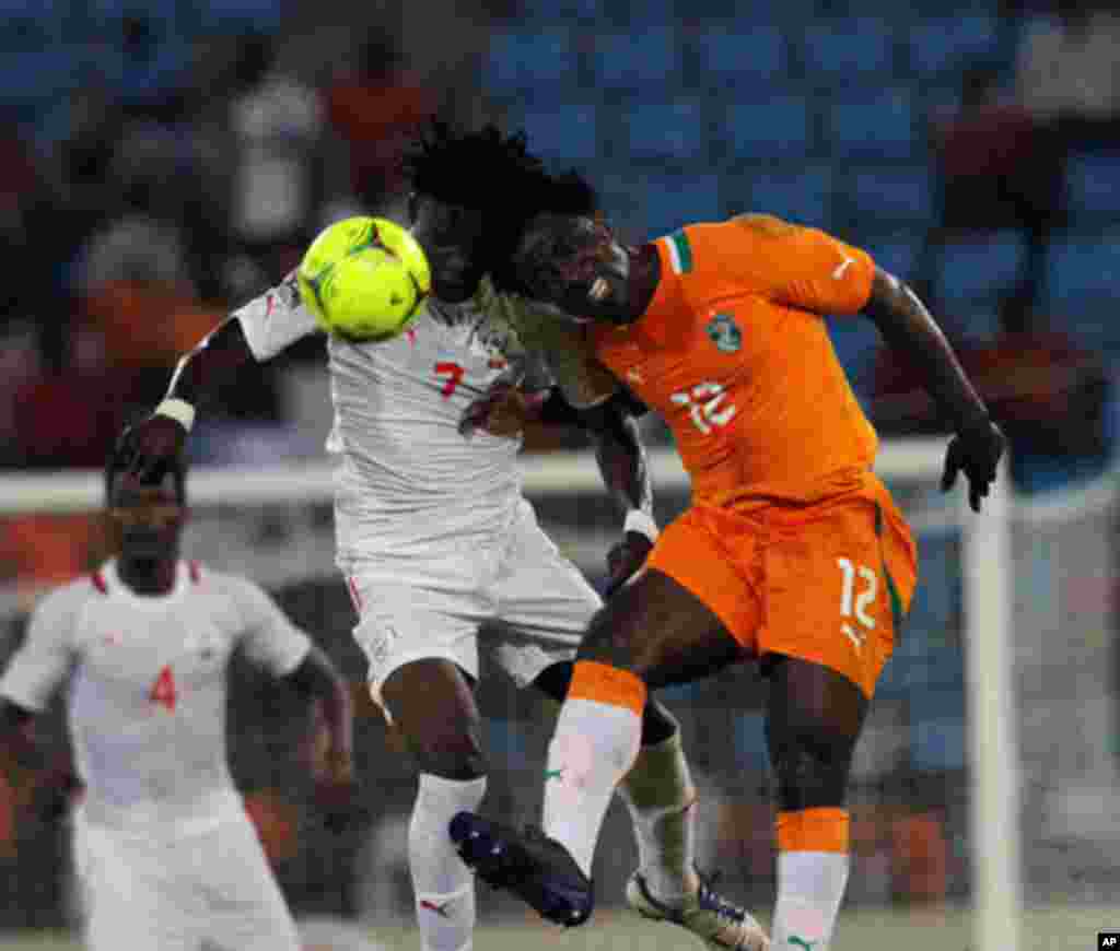 Bony of Ivory Coast fights for the ball with Rouamba of Burkina Faso during their African Nations Cup soccer match in Malabo