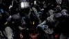 Riot police pour water on the face of an anti-government protester who was pepper sprayed while getting detained after an anti-parallel trading protest at Sheung Shui, a border town in Hong Kong, 