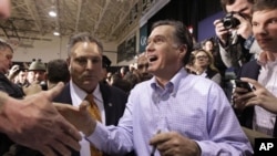 Republican presidential candidate, former Massachusetts Gov. Mitt Romney shakes hands as he campaigns during a town hall style meeting in Manchester, N.H., Wednesday, Jan. 4, 2012. (AP Photo/Stephan Savoia)