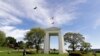 In this May 17, 2020, photo, a bird flies from the U.S. into Canada over the Peace Arch in Peace Arch Historical State Park on the border with Canada, where people can walk freely between the two countries at an otherwise closed border in Blaine, Wash..