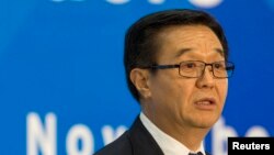 FILE - A former JPMorgan executive alleged that Chinese Commerce Minister Gao Hucheng, shown at a news conference in Beijing in November, sought favorable treatment for his son from the company.