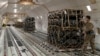 FILE - A senior airman inspects cargo netting on palletized ammunition, weapons and other equipment bound for Ukraine at Dover Air Force Base, Delaware, Jan. 24, 2022. (US Air Force photo/Roland Balik/Handout via Reuters)