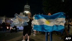 Argentinos celebran en el exterior del Congreso la suspensión de debate sobre las reformas presentadas por el presidente Javier Milei, en Buenos Aires el 6 de febrero de 2024.