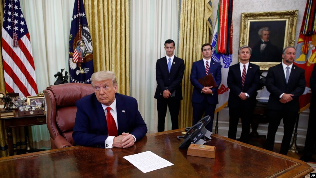 President Donald Trump participates in a law enforcement briefing on the MS-13 gang in the Oval Office of the White House, July 15, 2020, in Washington.
