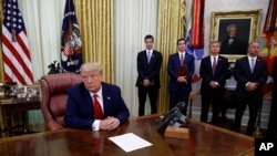 President Donald Trump participates in a law enforcement briefing on the MS-13 gang in the Oval Office of the White House, July 15, 2020, in Washington.