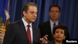 Manhattan U.S. Attorney Preet Bharara (L) announces on April 27, 2016, the arrest of more than 100 gang members in New York.