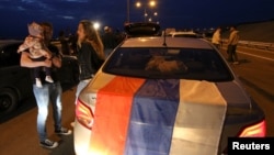 People gather before trip across the Kerch Strait Bridge, which was constructed to connect the Russian mainland with the Crimean Peninsula, May 16, 2018.