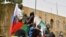 FILE —Young boys gather on top of a car while displaying flags of Niger, Burkina Faso and Russia during a demonstration for the immediate departure of United States Army soldiers deployed in northern Niger in Niamey, on April 13, 2024.