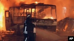 Firefighters in front of burning cars after an explosion near a police station in southern Turkish city of Gaziantep, Turkey, August 20, 2012. 