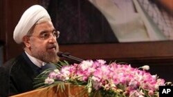 In this photo released by the official website of the office of Iranian President-elect Hasan Rouhani, Rouhani speaks in a conference in Tehran, June 29, 2013. 