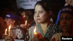 Women hold candles during a rally condemning the attack on schoolgirl Malala Yousufzai, Karachi, Pakistan, October 11, 2012. 