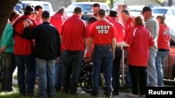 Members of the West Volunteer Fire Department gather after attending a service at St. Mary's Church of the Assumption, two days after an explosion at a fertilizer plant in West, Texas, April 19, 2013.