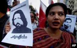 A woman holds a portrait of missing university professor and poet Salman Haider during a rally in support of Haider and other activists, in Karachi, Pakistan, Jan. 10, 2017.