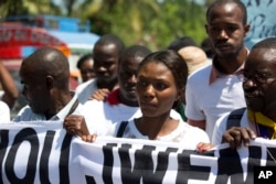 Fleurette Guerrier, the wife of missing photojournalist Vladjimir Legagneur, joins hundreds of journalists in a march to demand an investigation into why the freelance photographer vanished while on assignment, in Port-au-Prince, Haiti, March 28, 2018.
