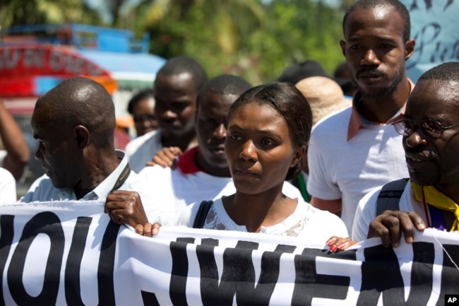 Fleurette Guerrier, the wife of missing photojournalist Vladjimir Legagneur, joins hundreds of journalists in a march to demand an investigation into why the freelance photographer vanished while on assignment, in Port-au-Prince, Haiti, March 28, 2018.