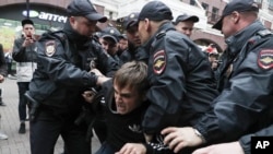 FILE - Police detain an activist during a protest in the center of Moscow, Russia, Aug. 17, 2019.