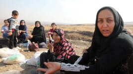 Displaced Kurds stuck at a border after a Turkish offensive in northeastern Syria, wait to try cross to the Iraqi side, at the Semalka crossing, next Derik city, Syria, Oct. 21, 2019.