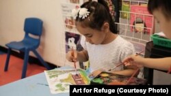 Children participate in the Art for Refuge program at Roshan Learning Center in Jakarta, Indonesia. The program was established by a 16-year-old Indonesian high school student to teach art to children and young people.