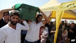 People carry a victim's coffin as they attend funeral services for dozens of people killed in last night's bomb attack targeting an outdoor wedding party in Gaziantep, southeastern Turkey, Aug. 21, 2016. 