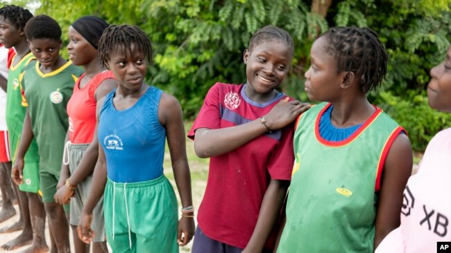 Young women coached by Isabelle Sambou, two-time Olympian and nine-time African wrestling champion, wait before a wrestling training in Mlomp, southern Senegal, July 10, 2024.
