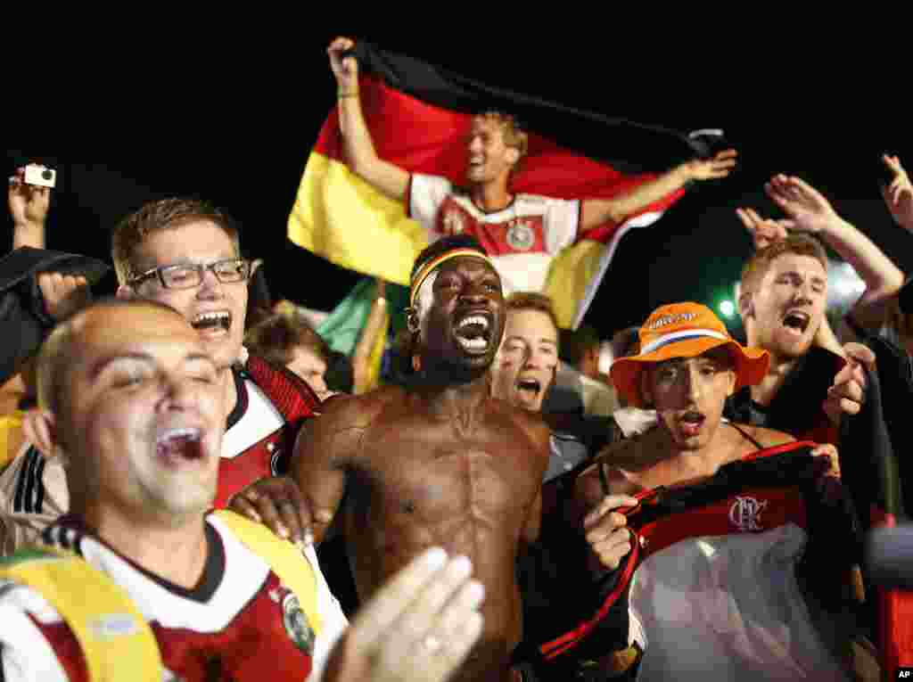 Germany soccer fans celebrate their team's 7-1 victory over Brazil after watching the World Cup semifinal match on a live telecast inside the FIFA Fan Fest area on Copacabana beach in Rio de Janeiro, Brazil, July 8, 2014.