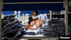 FILE - An employee sorts pieces of cloth at the Estee garment factory in Tirupur, in the southern Indian state of Tamil Nadu.