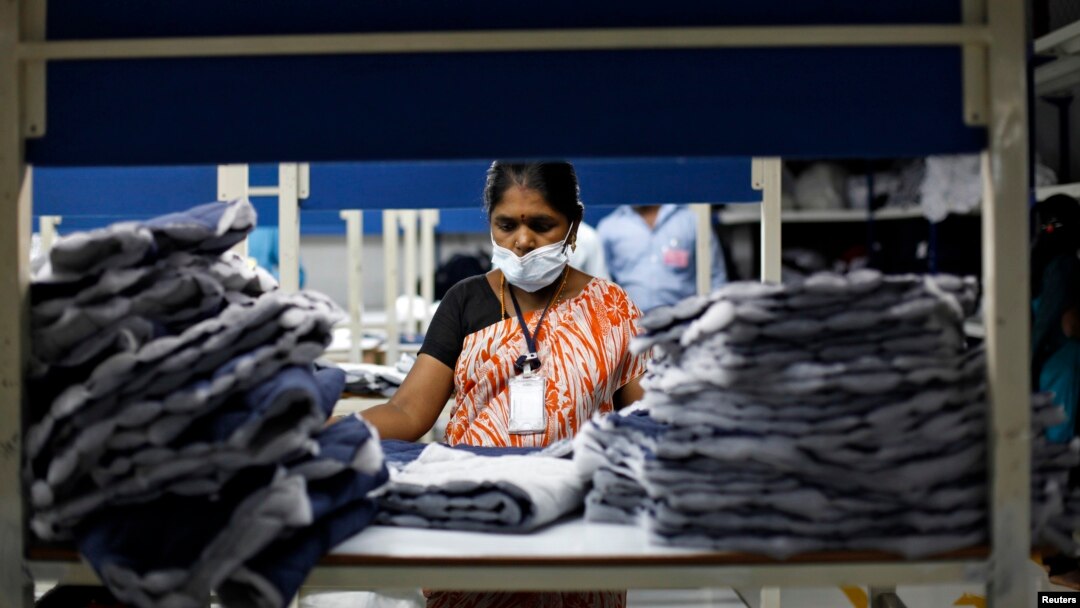 FILE - An employee sorts pieces of cloth at the Estee garment factory in Tirupur, in the southern Indian state of Tamil Nadu.