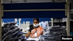 FILE - An employee sorts pieces of cloth at the Estee garment factory in Tirupur, in the southern Indian state of Tamil Nadu.