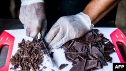 Preparation of a chocolate ganache with local rum by chocolate maker Ralph Leroy in the workshops of Makaya Chocolat on December 23, 2020 in Petionville, Haiti. 