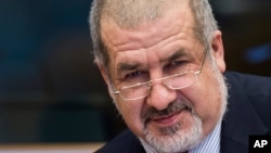 Crimean Tatar community leader Refat Chubarov arrives for a Security and Defense Committee meeting at the European Parliament in Brussels on Tuesday, March 24, 2015. The committee exchanged views on the militarization of Crimea and the security situation one year after the annexation by Russia. (AP Photo/Geert Vanden Wijngaert)