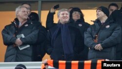 FILE - Rinat Akhmetov is seen flanked at a soccer match by Sweden's Foreign Minister Carl Bildt (L) and Poland's Foreign Minister Radoslaw Sikorski (R) Nov. 23, 2011, in Donetsk, Ukraine. 