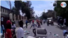 Protesters throw trash on street during a demonstration against President Jovenel Moise in Gonaïves, Haiti, June 14, 2019. 