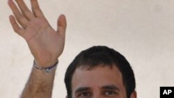 Rahul Gandhi waves during an election campaign rally ahead of state assembly elections in the southern Indian state of Tamil Nadu, April 6, 2011